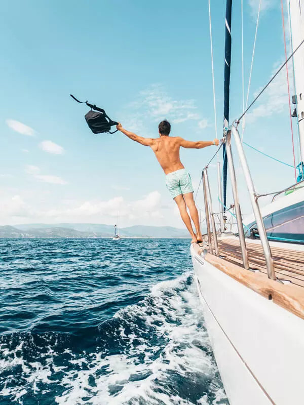 A-Man-standing-by-the-edge-of-a-boat-in-a-boat-trip-in-Greece-