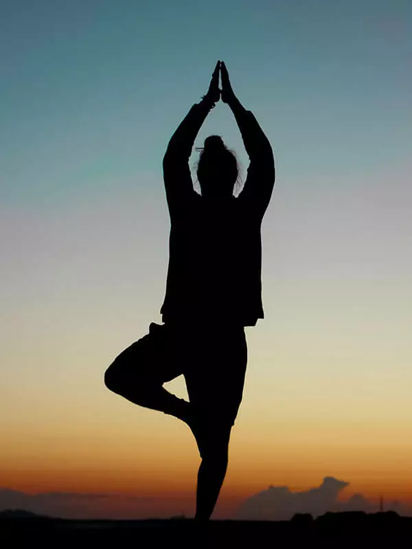 yoga-man-doing-a-pose-during-sunset
